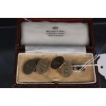 A pair of 9ct gold oval cufflinks with engraved initials to one side and engraved acorn to the