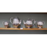 A silver plated melon fluted four piece tea set with engraved decoration