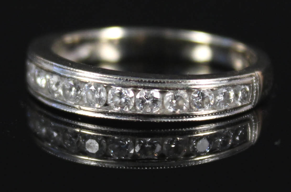 An 18ct white gold diamond band ring set with fourteen brilliant cut diamonds,