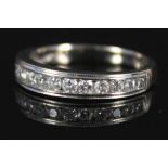 An 18ct white gold diamond band ring set with fourteen brilliant cut diamonds,