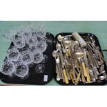 Various cut wine glasses and silver plated cutlery (two trays)