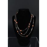 An opera length silver and coral necklace