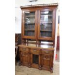 A substantial Edwardian American walnut cupboard bookcase with adjustable shelves and glazed