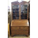 An early 19th Century mahogany and oak bureau bookcase (marriage)