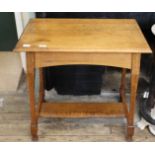 An oak tapered legged occasional table with shelf underneath