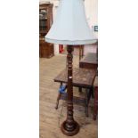 A modern carved mahogany standard lamp with cream shade