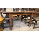 A substantial 1920's carved oak extending dining table