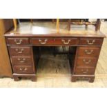 A 1920's mahogany leather topped pedestal desk