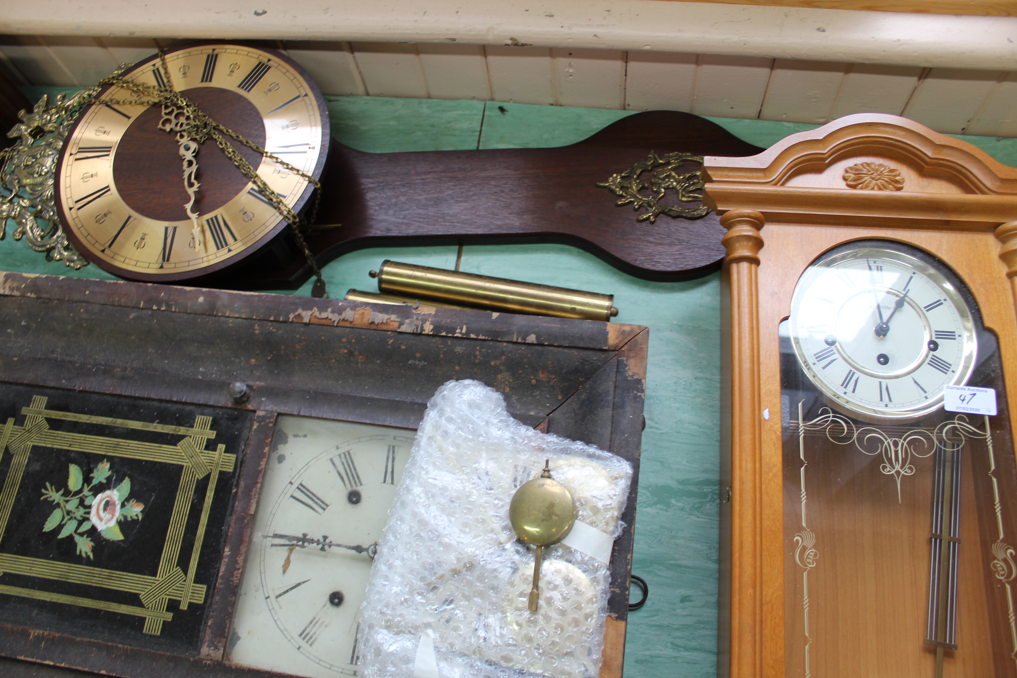 A modern English made wall clock with weights and pendulum,