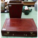 A vintage leather briefcase with combination lock plus a red painted waste paper bin