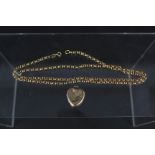 A 9ct gold belcher link chain together with yellow metal heart shaped locket