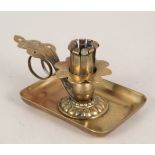 An Arts and Crafts adjustable brass chamberstick stamped 'K.K.Oestr Patent' and 'D.R.