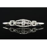 A precious metal Art Deco style diamond set bracelet, the central stone (approx 0.