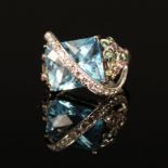A decorative 18ct white gold blue topaz and diamond ring,
