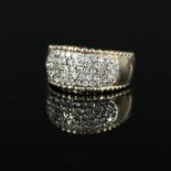 A 9ct gold wide band ring set with diamonds with gold bead border,