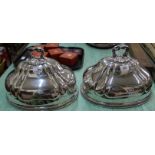 A pair of silver plated meat domes with engraved crests