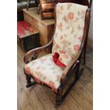 A mid 19th Century mahogany rocking chair with floral upholstery