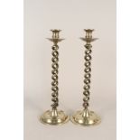 A large pair of late Victorian open barley twist brass candlesticks with drip trays and wide dished
