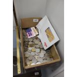 A box of mixed world coins and banknotes (some current)