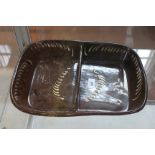 A Newcastle slip ware baking dish with white dash sprays