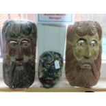 A group of three painted South American masks