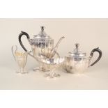 A Victorian four piece silver plated tea set with engraved decoration and cast finials