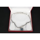 A large silver and 14ct gold blue stone set pendant on double strand bead link necklace