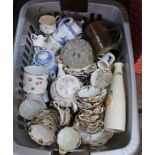 A basket containing a quantity of assorted ceramics including a part tea set and a brass tankard