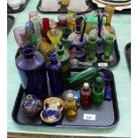 A quantity of assorted coloured glassware and bottles including hand painted examples (two trays)