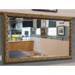 A gilt mirror with bevelled glass,
