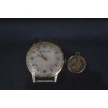 A 9ct gold presentation Astral Smiths watch plus a yellow metal St Christopher charm (as found)