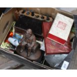 A box of assorted items including two cased instruments, pipe rack and pipes,