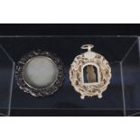 A small round Chinese silver frame with pierced dragon decoration together with an ornate ivory