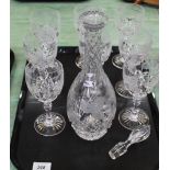 A tray of eight cut glass wine glasses with etched vine leaf decoration plus a cut glass decanter
