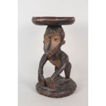 A West African tribal stool from the Cameroon depicting a monkey
