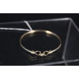 A 9ct gold bangle,