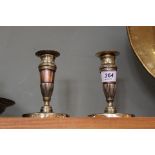 A pair of early 19th Century French brass and copper candlesticks with fluted and chased decoration,