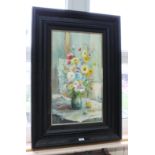 An oil on canvas depicting a floral still life scene, signed lower left, in heavily ebonised frame,