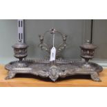 A Victorian style brass embossed foliate and classical urn designed double inkwell stand