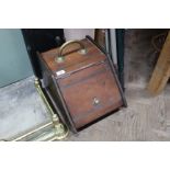 An Edwardian American walnut coal box with shovel