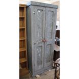 A late 20th Century painted pine two door cupboard with lead panels