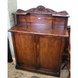 An early 19th Century mahogany two door cupboard with shelved upstand