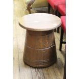 An occasional table in the form of a small oak barrel with small cupboard below