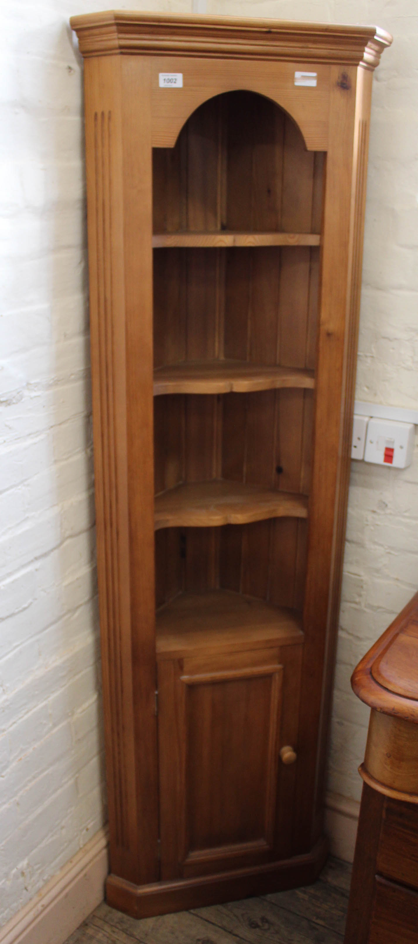 A late 20th Century pine corner cupboard