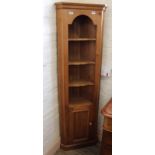 A late 20th Century pine corner cupboard