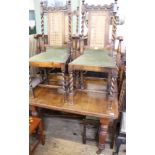 A late Victorian mahogany extending dining table with five oak dining chairs including two carvers