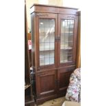 A early 20th Century oak part lead glazed four door cupboard