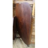 An early Victorian tilt top mahogany table with brass castors