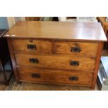 An Edwardian oak four drawer chest with plate handles