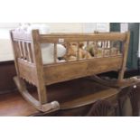 An Edwardian ash rocking cradle with assorted bears